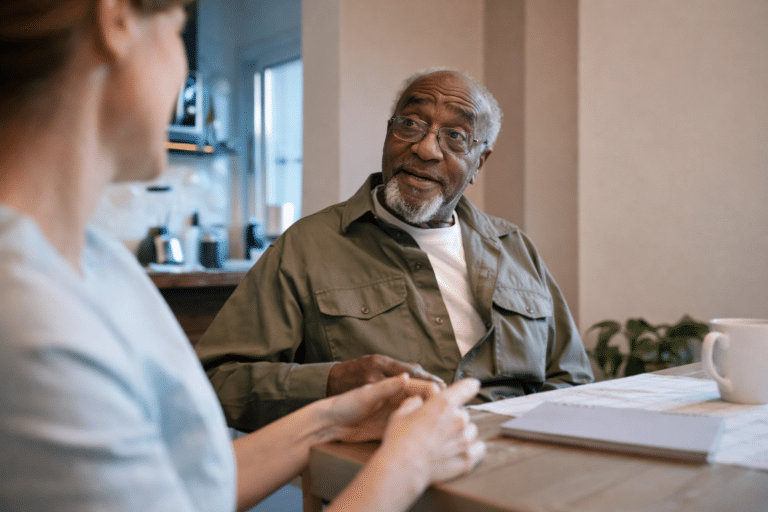 Nursing staff talking with old man