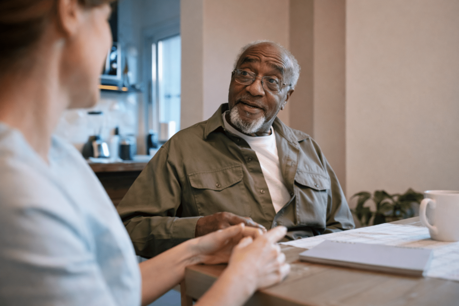 Nursing staff talking with old man