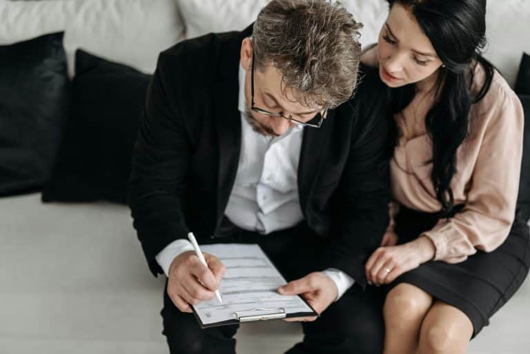 Family member helping elderly parent complete attendance allowance application form