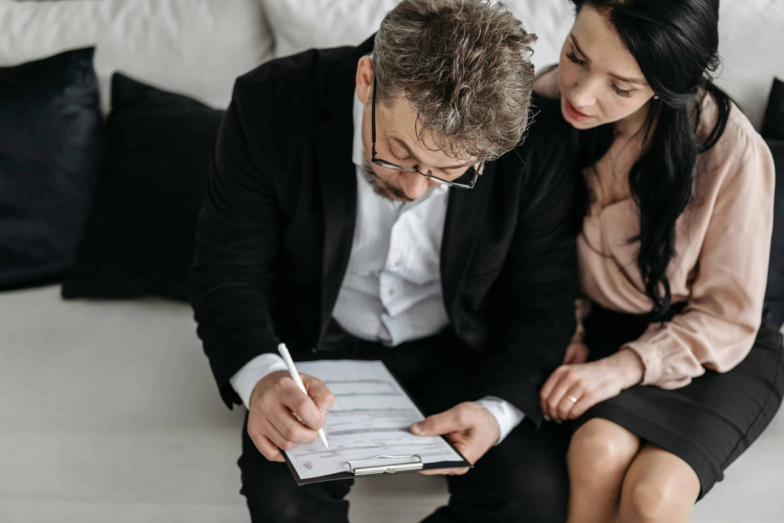 Family member helping elderly parent complete attendance allowance application form